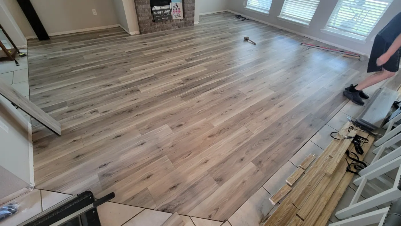 Light plank flooring in a living room with a brick fireplace in a Tulsa, OK home